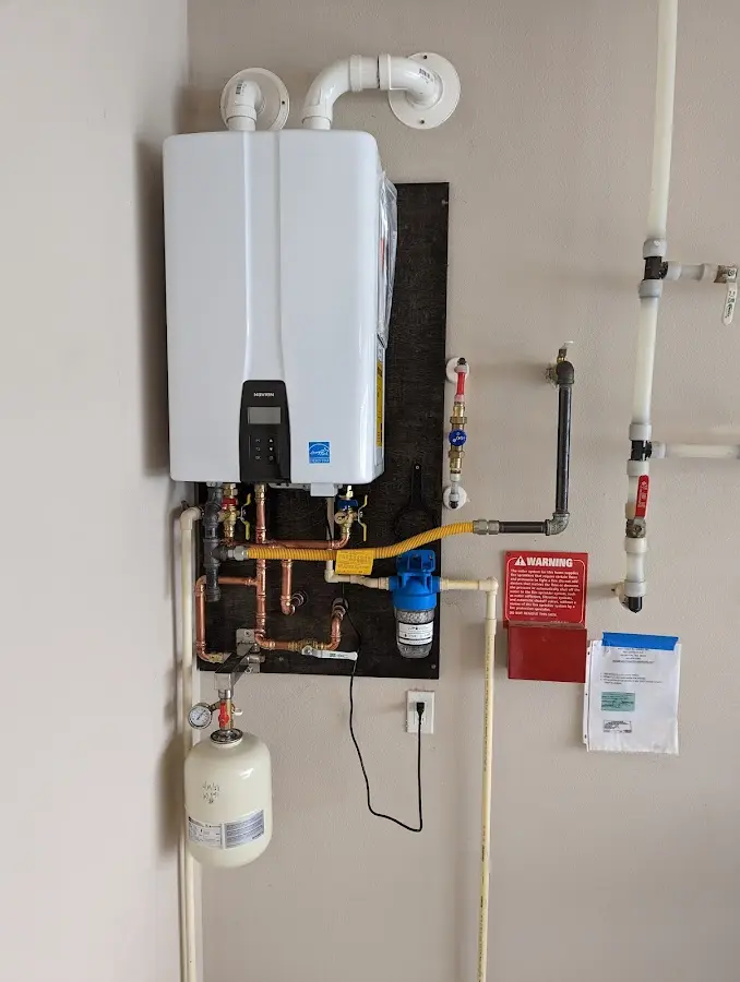 Professional plumber installing copper piping in a Salina home